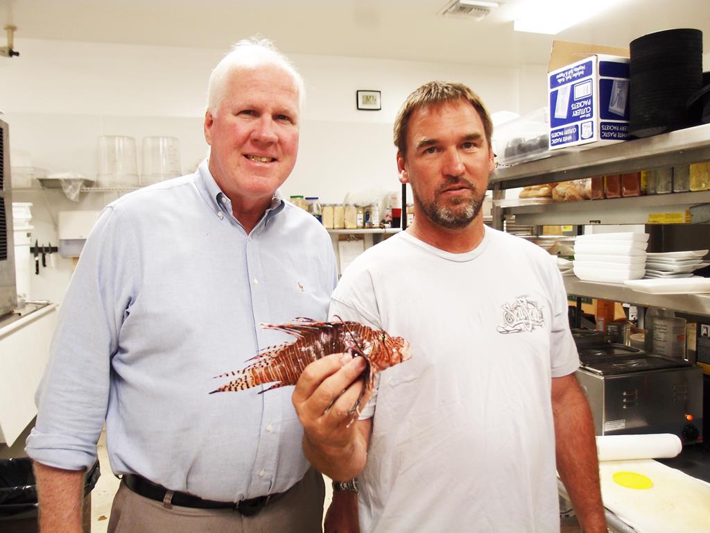 Local businesses banding together to eradicate lionfish: George Husum, owner of g. Foley's restaurant with Clay Galbreath, owner of Diver's Den