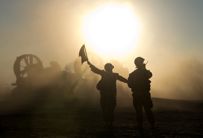 An MH-60S air crewman with Helicopter Sea Combat Squadron 28, Iwo Jima Amphibious Ready Group, gazes out of the gunner’s door of a Seahawk helicopter while participating in flight operations over the Atlantic Ocean. Flight operations are in support of a simulated strait transit during Composite Training Unit Exercise with the 24th Marine Expeditionary Unit in preparation for the deployment at the end of the year. (U.S. Navy courtesy photo)