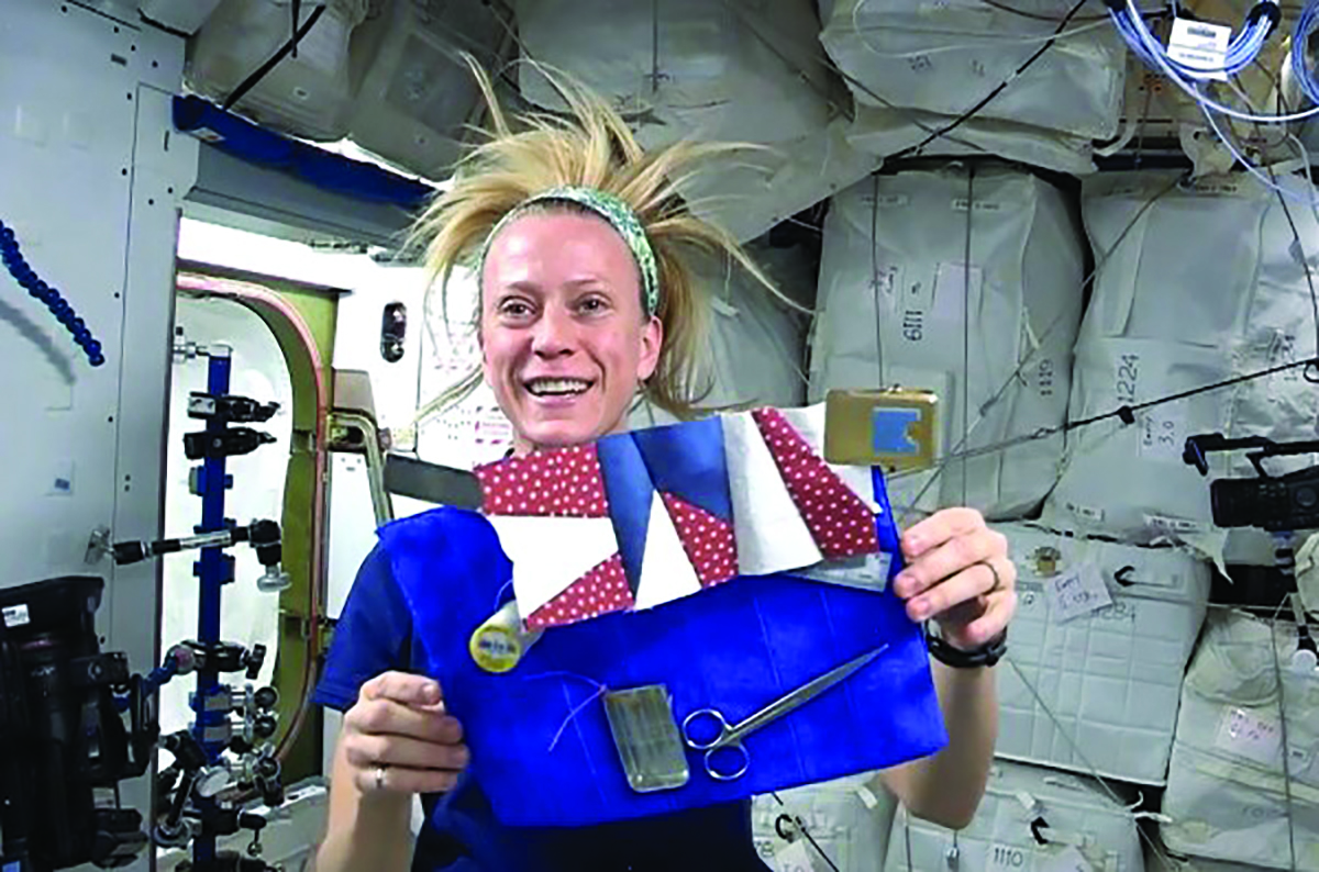 Astronaut Karen Nyberg displays the velcro workboard she uses while sewing and quilting aboard the space station. - Photo Credit NASA TV