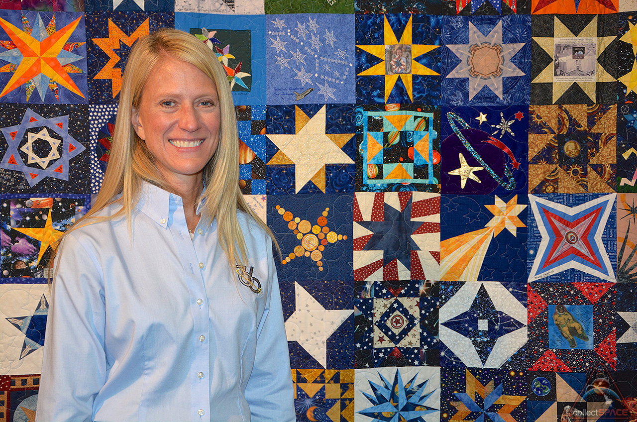 Astronaut Karen Nyberg poses with her and others' star-themed blocks at the International Quilt Festival in Houston. - Photo Credit CollectSpace.com