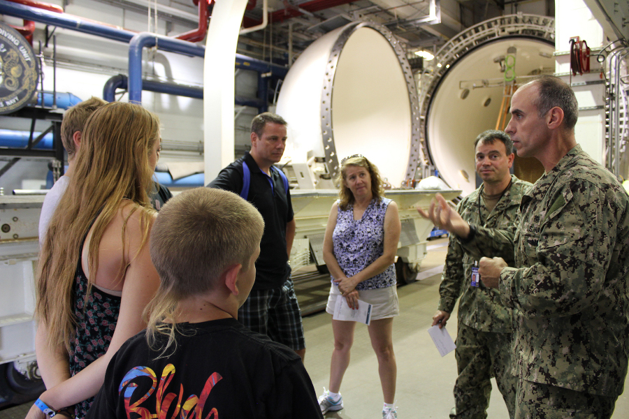 Navy Experimental Diving Unit (NEDU) Command Master Chief Navy Diver, Master Chief Petty Officer (MDV/SG) Louis Deflice speaks to the family of former NEDUC Commanding Officer Capt. Charles “Black Bart” Bartholomew during a Home of Military Diving tour June 15, 2015 in Panama City, Florida. Bartholomew was at NEDU from 1977 to 1980 and was also the former Director, Supervisor of Salvage. He died in 1990. (RELEASED/Photo by Katherine Mapp, NSWC PCD Public Affairs).
